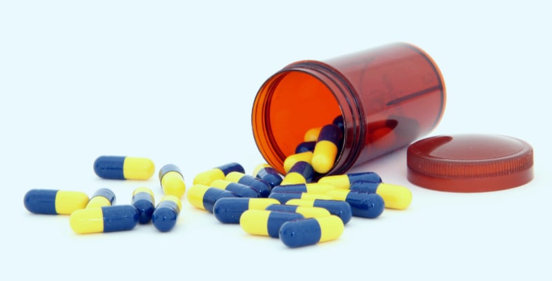 Medication capsule bottle and pills